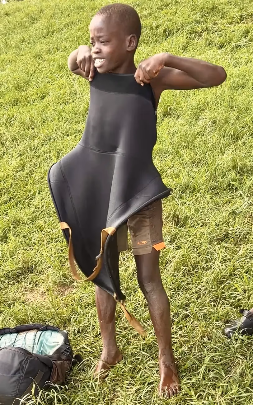 Boy in oversized wetsuit